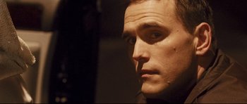Movie still from “Crash” (2004), directed by Paul Haggis – A man's face in the dark; Close Up shot, Low angle