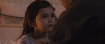 Movie still from “Crash” (2004), directed by Paul Haggis – A little girl sitting in front of a man; Close Up shot, Over the shoulder angle