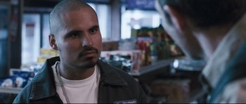 Movie still from “Crash” (2004), directed by Paul Haggis – A person wearing a jacket in a store; Close Up shot, Over the shoulder angle