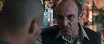 Movie still from “Crash” (2004), directed by Paul Haggis – A person looking at another person; Close Up shot, Over the shoulder angle