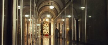Movie still from “Crash” (2004), directed by Paul Haggis – A person walking in a hallway near a christmas tree; Extreme Wide shot, Low angle