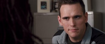 Movie still from “Crash” (2004), directed by Paul Haggis – A person sitting in front of another person; Close Up shot, Over the shoulder angle