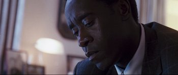 Movie still from “Crash” (2004), directed by Paul Haggis – A person wearing a suit and tie; Close Up shot, Low angle