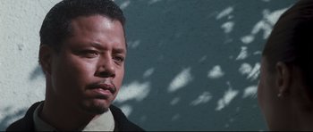 Movie still from “Crash” (2004), directed by Paul Haggis – A person wearing a suit and tie; Close Up shot, Low angle