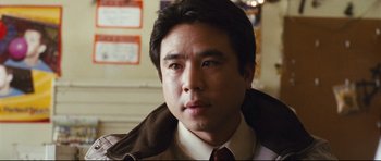 Movie still from “Crash” (2004), directed by Paul Haggis – A person wearing a suit and tie; Close Up shot, Low angle