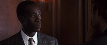 Movie still from “Crash” (2004), directed by Paul Haggis – A man wearing a suit and tie looking up; Close Up shot, Over the shoulder angle