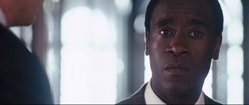 Movie still from “Crash” (2004), directed by Paul Haggis – A person wearing a suit and tie; Close Up shot, Low angle