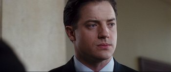 Movie still from “Crash” (2004), directed by Paul Haggis – A person wearing a suit and tie; Close Up shot, High angle