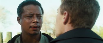 Movie still from “Crash” (2004), directed by Paul Haggis – Two men talking to each other in front of trees; Close Up shot, Over the shoulder angle