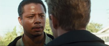 Movie still from “Crash” (2004), directed by Paul Haggis – Two men talking to each other in front of trees; Close Up shot, Over the shoulder angle