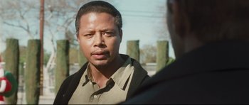 Movie still from “Crash” (2004), directed by Paul Haggis – A person wearing a shirt and jacket; Close Up shot, Over the shoulder angle