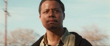 Movie still from “Crash” (2004), directed by Paul Haggis – A person wearing a shirt and jacket; Close Up shot, Low angle