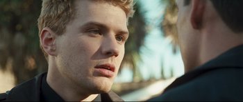 Movie still from “Crash” (2004), directed by Paul Haggis – A young man's face with trees in the background; Close Up shot, Over the shoulder angle