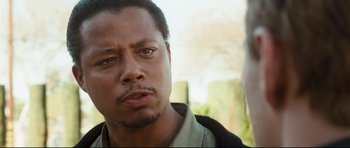 Movie still from “Crash” (2004), directed by Paul Haggis – A man's face with trees in the background; Close Up shot, Over the shoulder angle