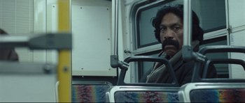 Movie still from “Crash” (2004), directed by Paul Haggis – A man sitting on a bus looking out of the window; Close Up shot, Low angle