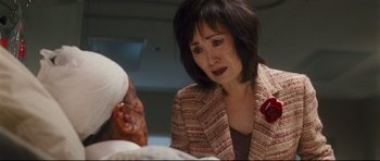 Movie still from “Crash” (2004), directed by Paul Haggis – An asian woman in a red and white jacket; Close Up shot, Over the shoulder angle