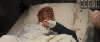 Movie still from “Crash” (2004), directed by Paul Haggis – An old man in a hospital bed with a bandaged arm; Close Up shot, Overhead angle