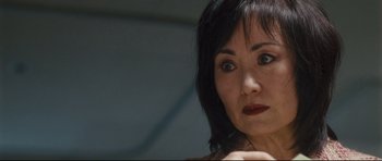 Movie still from “Crash” (2004), directed by Paul Haggis – A person with short black hair; Close Up shot, Low angle