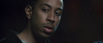 Movie still from “Crash” (2004), directed by Paul Haggis – A man's face in a dark room; Close Up shot, Low angle