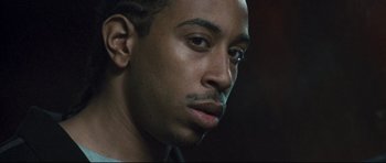 Movie still from “Crash” (2004), directed by Paul Haggis – A man's face in a dimly - lit room; Close Up shot, Low angle