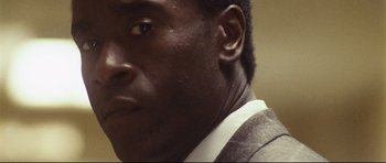 Movie still from “Crash” (2004), directed by Paul Haggis – A man in a suit looking into the distance; Extreme Close Up shot, Low angle