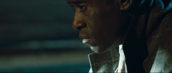 Movie still from “Crash” (2004), directed by Paul Haggis – A man's face in a dark room; Extreme Close Up shot, Over the shoulder angle