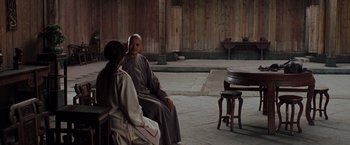 Movie still from “Crouching Tiger, Hidden Dragon” (2000), directed by Ang Lee – A man and a woman sitting on a bench; Wide shot, Over the shoulder angle