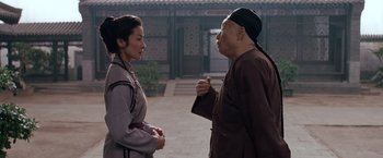 Movie still from “Crouching Tiger, Hidden Dragon” (2000), directed by Ang Lee – A woman and an older man talking in a courtyard; Medium shot, Over the shoulder angle