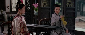 Movie still from “Crouching Tiger, Hidden Dragon” (2000), directed by Ang Lee – Two people sitting at a table in a room; Medium shot, Over the shoulder angle