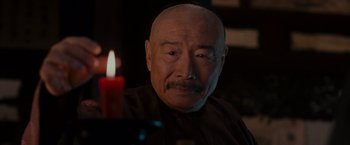 Movie still from “Crouching Tiger, Hidden Dragon” (2000), directed by Ang Lee – An older man sitting in front of a lit candle; Close Up shot, Over the shoulder angle
