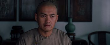 Movie still from “Crouching Tiger, Hidden Dragon” (2000), directed by Ang Lee – A man with a shaved head is looking at the camera; Close Up shot, Over the shoulder angle