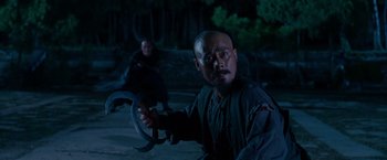 Movie still from “Crouching Tiger, Hidden Dragon” (2000), directed by Ang Lee – A man holding a steering wheel in front of a woman; Medium shot, Low angle