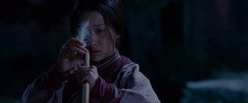 Movie still from “Crouching Tiger, Hidden Dragon” (2000), directed by Ang Lee – A woman holding a white feather in her hand; Close Up shot, Low angle