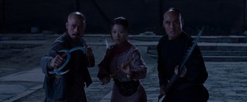 Movie still from “Crouching Tiger, Hidden Dragon” (2000), directed by Ang Lee – A group of people standing next to each other on a street; Medium shot, Low angle