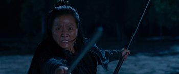 Movie still from “Crouching Tiger, Hidden Dragon” (2000), directed by Ang Lee – An asian woman holding a sword in a dark setting; Close Up shot, Low angle