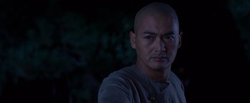 Movie still from “Crouching Tiger, Hidden Dragon” (2000), directed by Ang Lee – A man with a shaved head is posing for the camera; Close Up shot, Low angle