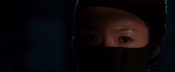 Movie still from “Crouching Tiger, Hidden Dragon” (2000), directed by Ang Lee – A person with a black mask on their face; Extreme Close Up shot, High angle