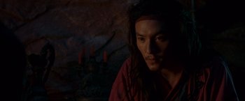 Movie still from “Crouching Tiger, Hidden Dragon” (2000), directed by Ang Lee – A man with long black hair wearing a red shirt; Close Up shot, High angle