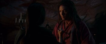 Movie still from “Crouching Tiger, Hidden Dragon” (2000), directed by Ang Lee – A man with long black hair is holding a pipe; Close Up shot, High angle