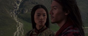 Movie still from “Crouching Tiger, Hidden Dragon” (2000), directed by Ang Lee – A man and a woman standing next to each other in front of mountains; Close Up shot, Over the shoulder angle