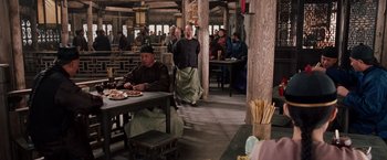 Movie still from “Crouching Tiger, Hidden Dragon” (2000), directed by Ang Lee – A group of people sitting at a table in a restaurant; Wide shot, Over the shoulder angle