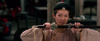Movie still from “Crouching Tiger, Hidden Dragon” (2000), directed by Ang Lee – A young man holding a sword in his hand; Close Up shot, Over the shoulder angle