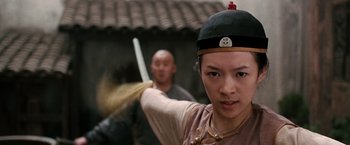 Movie still from “Crouching Tiger, Hidden Dragon” (2000), directed by Ang Lee – A young man holding a sword in front of another man; Close Up shot, Low angle