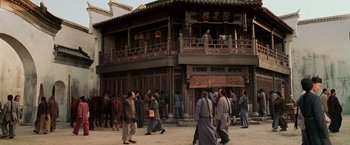 Movie still from “Crouching Tiger, Hidden Dragon” (2000), directed by Ang Lee – A group of people walking in front of a building; Extreme Wide shot, Low angle