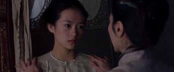 Movie still from “Crouching Tiger, Hidden Dragon” (2000), directed by Ang Lee – A woman looking in a mirror while another woman is touching her face; Close Up shot, Over the shoulder angle