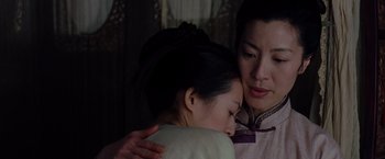 Movie still from “Crouching Tiger, Hidden Dragon” (2000), directed by Ang Lee – A woman hugging another woman in front of a window; Close Up shot, Over the shoulder angle