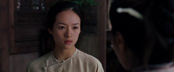 Movie still from “Crouching Tiger, Hidden Dragon” (2000), directed by Ang Lee – A young asian woman looking at the camera; Close Up shot, Over the shoulder angle