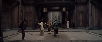 Movie still from “Crouching Tiger, Hidden Dragon” (2000), directed by Ang Lee – A group of people are practicing martial arts in an oriental setting; Wide shot, Low angle