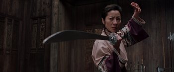 Movie still from “Crouching Tiger, Hidden Dragon” (2000), directed by Ang Lee – A woman is holding a sword in her hand; Medium shot, Low angle
