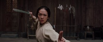 Movie still from “Crouching Tiger, Hidden Dragon” (2000), directed by Ang Lee – A woman in a white shirt is holding a sword; Close Up shot, Low angle